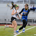 Sophomore Shannon Siebold takes the ball down the field past Brookfield's Savannah Ryan. 